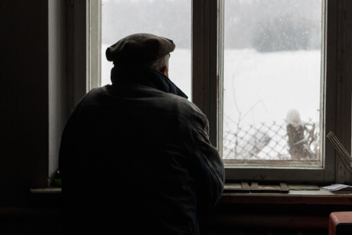 A man looking out of a window.