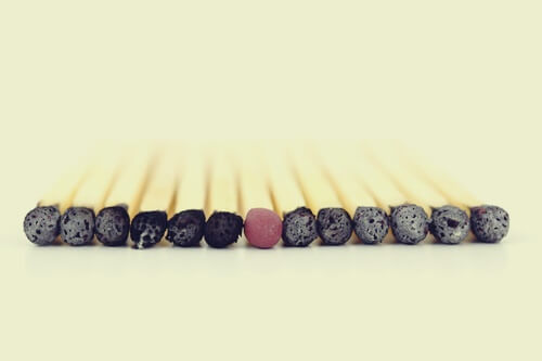 An untouched match in the middle of burnt ones.