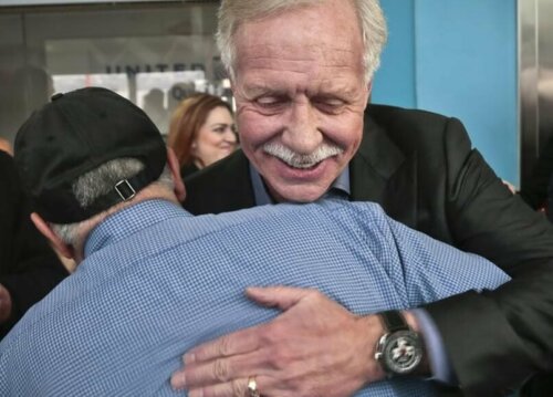 Sully hugging a man.