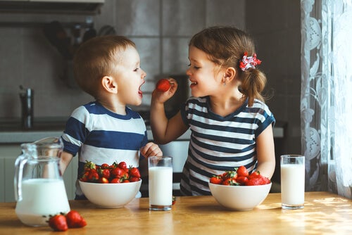 A brother and sister eating.