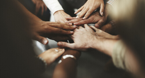 Hands in the middle of a circle.