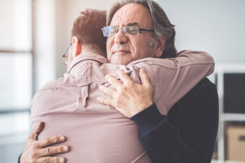 Two people hugging.