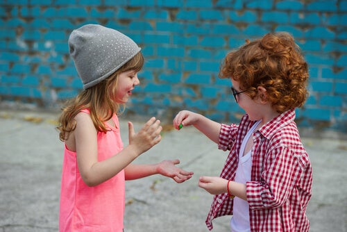 Two kids sharing treats.