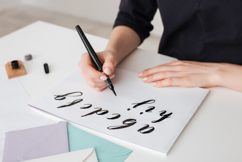 A woman doing lettering.