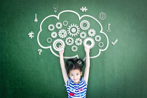 A little girl in front of a drawing of a brain.