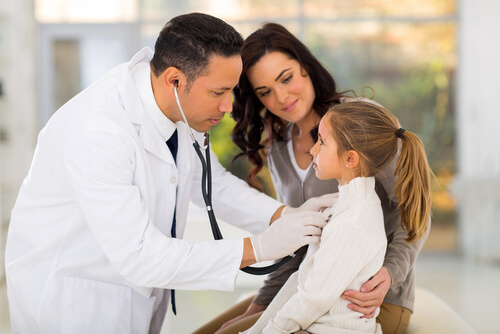 A doctor giving a little girl a check-up.
