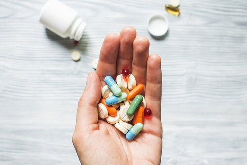 A person with a handful of pills.
