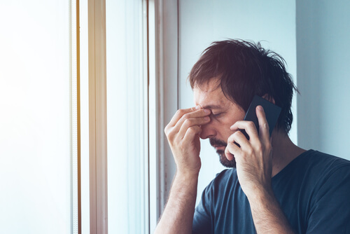 A stressed man on the phone.
