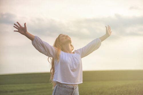 A woman with her arms up.