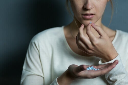 A woman taking pills.