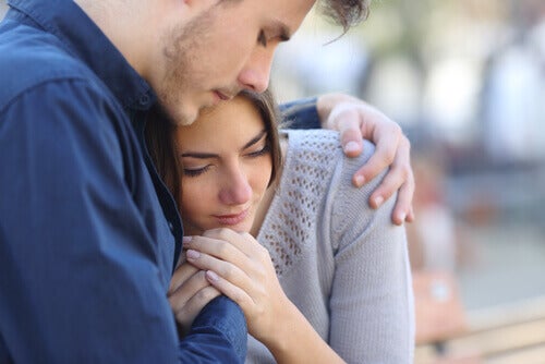 A man comforting a woman.