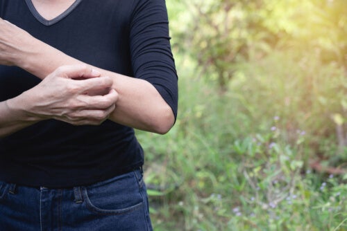 A person scratching themselves.