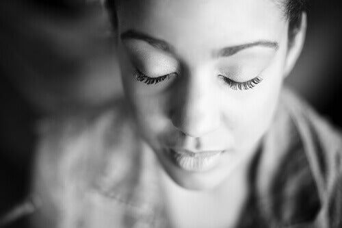 A woman with her eyes closed.