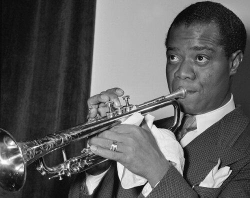 Louis Armstrong playing an instrument.