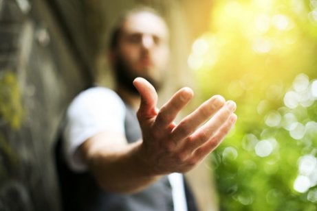 A guy looking at his hand.