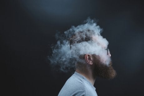 A guy with his head in smoke.