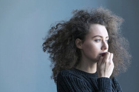 A curly-haired woman looking off to the side.