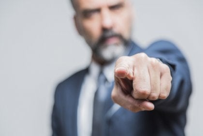 An angry man showing the body language of controlling people.