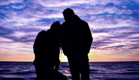 A couple looking at the sunset.