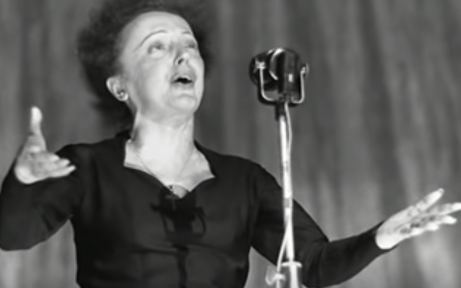 Édith Piaf performing on stage.