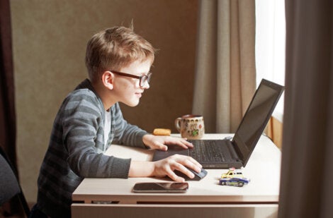 A kid playing on a laptop in a world of digitization.