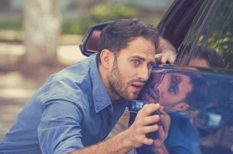 A man cleaning his car.