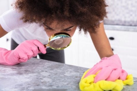 A woman cleaning her kitchen counters.