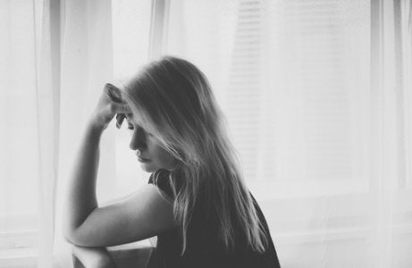 A woman looking sad and pensive.