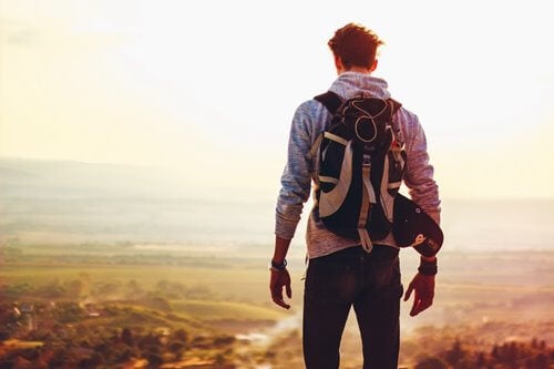 A backpacker on top of a mountain.