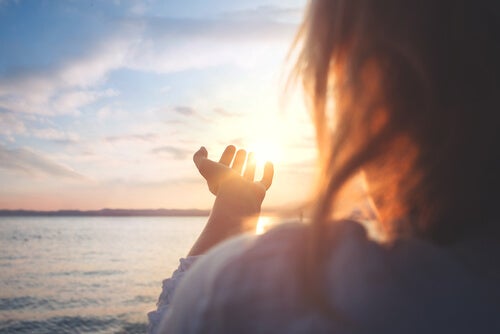 A person holding the sun.