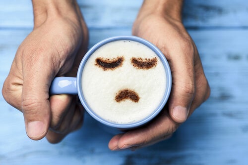 A coffee cup with a sad face.