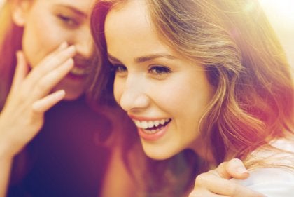 Two women spreading gossip.