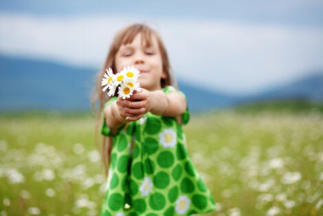 A girl holding a bunch of flowers.