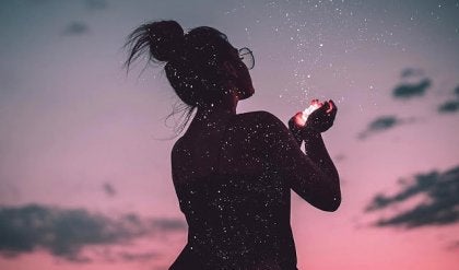 A woman holding a handful of stars.