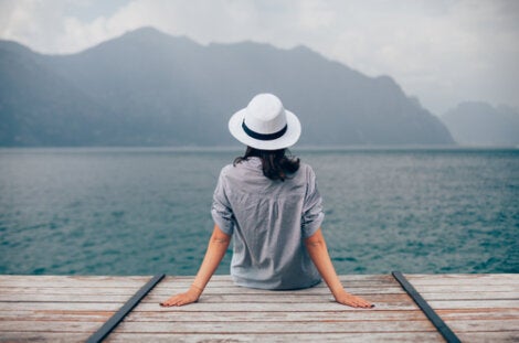 A woman sitting on a pier.