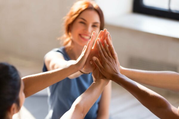 A group of friends high-fiving.