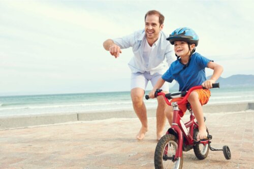 A man teaching a child to bike.