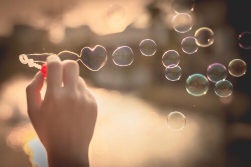 A person blowing bubbles.