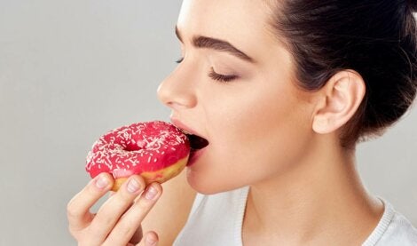 A woman eating a donut.