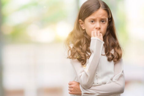 A girl biting her nails.