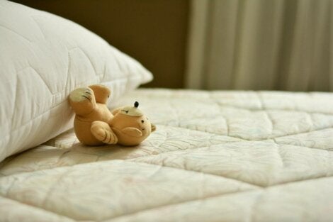 A little bear on a pillow.