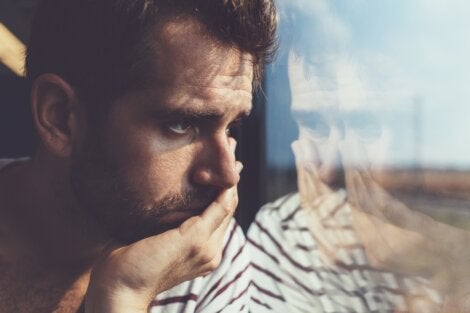 A sad guy looking out the window.