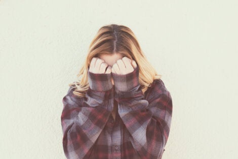 A woman covering her face.