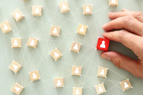 A person holding different chips with people on them, representing the psychology of personality.