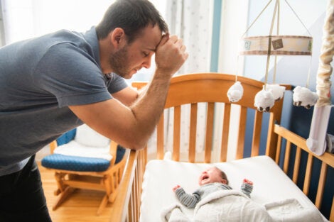 A dad with a crying baby.