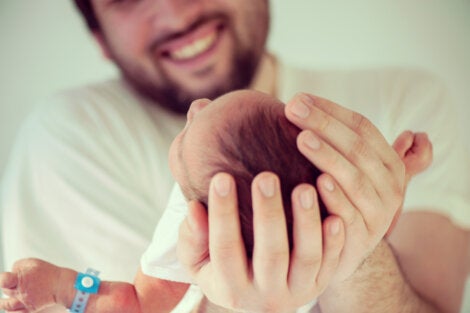A father holding his baby.