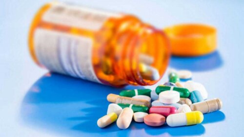 An orange bottle full of prescription medications.