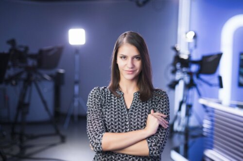 A TV show host smiling at the camera.