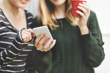 Two women looking at a phone.