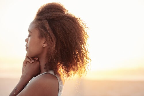 A woman practicing emotional self-regulation during sunset.